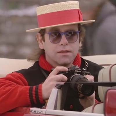 Elton John holding a camera